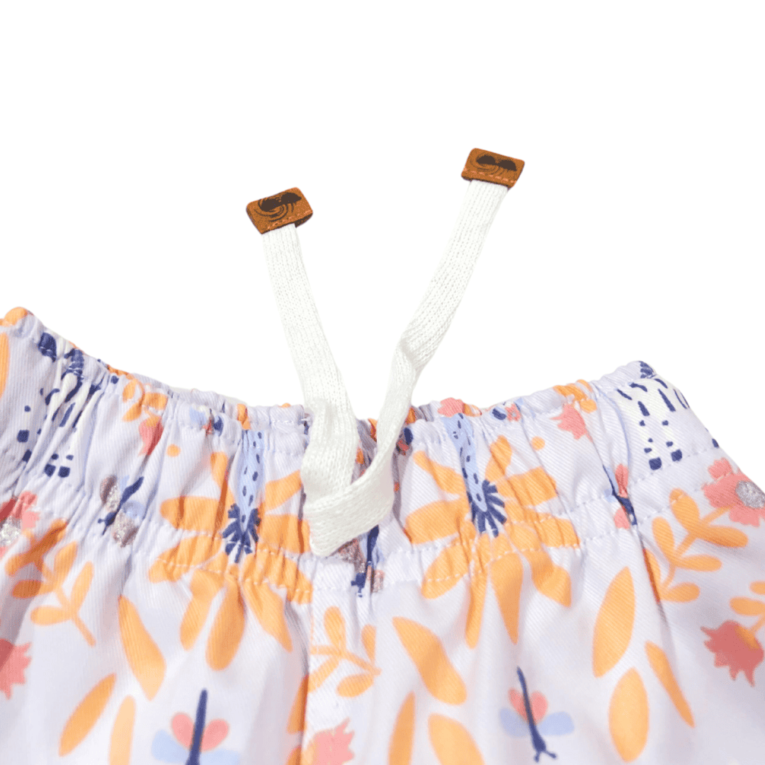 OUT|Short Niña Flores tono Naranja fondo lila